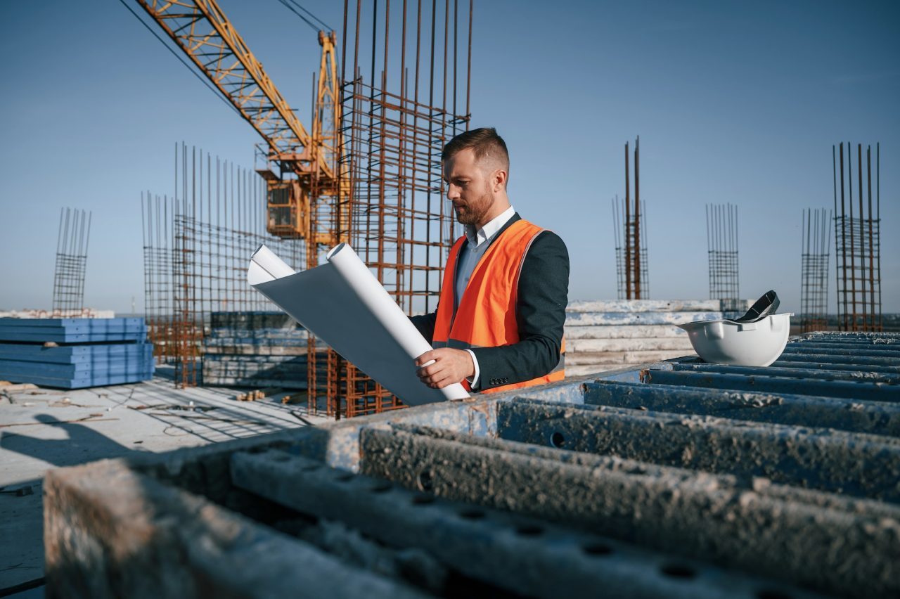 reading-the-plan-man-is-working-on-the-construction-site-at-daytime.jpg