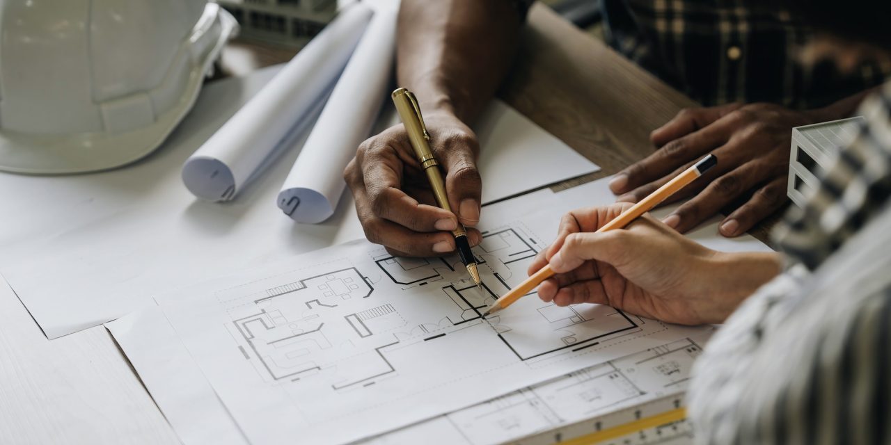team-construction-engineers-working-at-construction-site-with-blueprint-on-table.jpg